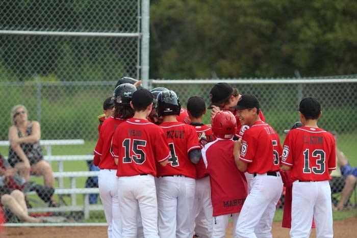  The team celebrated with Leach after his home-run.