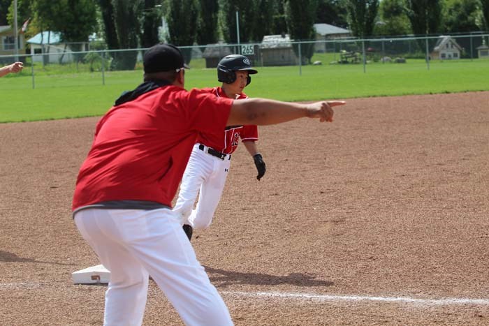  Caiden Kim rounds third as his coach Helly Kim gives him the ok to run home.