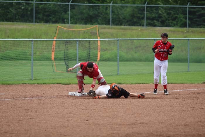  The Mustangs' catcher tags the runner out at third after a run-down play.