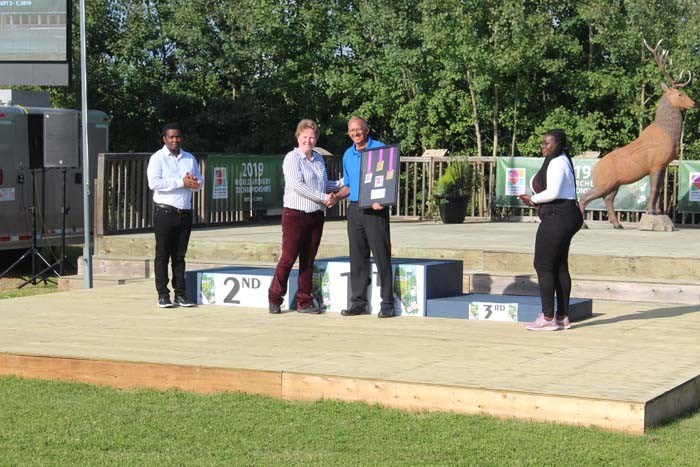  Rene Schaub is presented with a framed collection of the victory medals from the 2019 World Archery 3D Championships by World Archery Technical Delegate Hannah Brown from Great Britain.