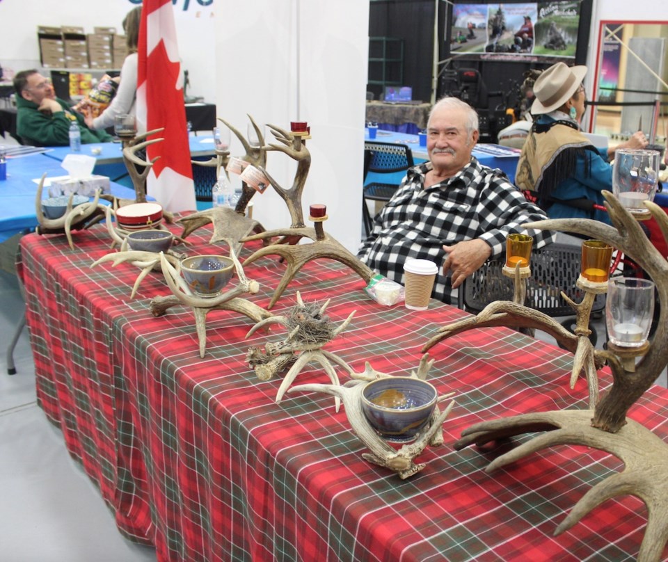  Marcel Turgeon from Naturally Crafted with displays of deer horn chandeliers and Lamps