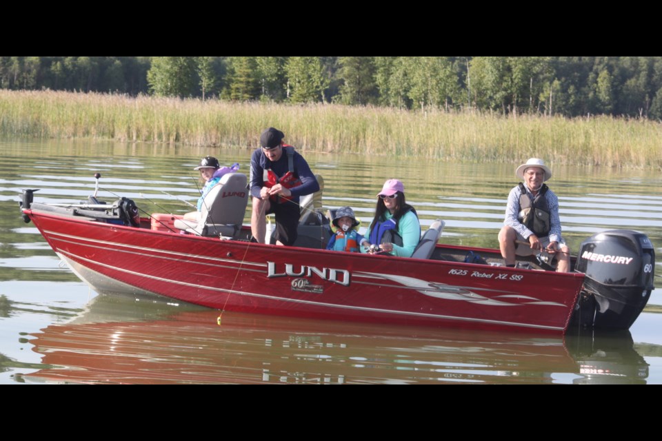 Jason Hebert (standing, red life jacket), along with family members, were amongst the group of folks from the Lac La Biche area and beyond who participated in the Lac La Biche Pow Wow Days fish derby, which was held on Beaver Lake on Aug. 2. Chris McGarry photo. 