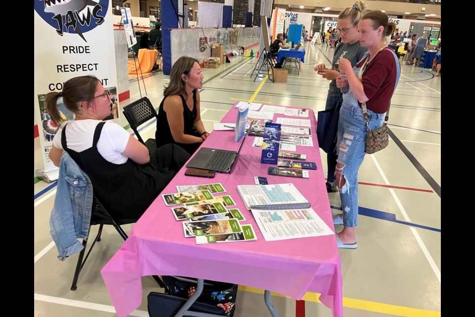 Jen Mah, a teacher at JA Williams (JAWS) High School in Lac La Biche and Missy Jacknife, a graduation coach, speak with Heather Coolgan and Shayla Janz at the CARE (Community Awareness Registration Event) that took place at Lac La Biche’s Bold Centre on June 18. Chris McGarry photo.
