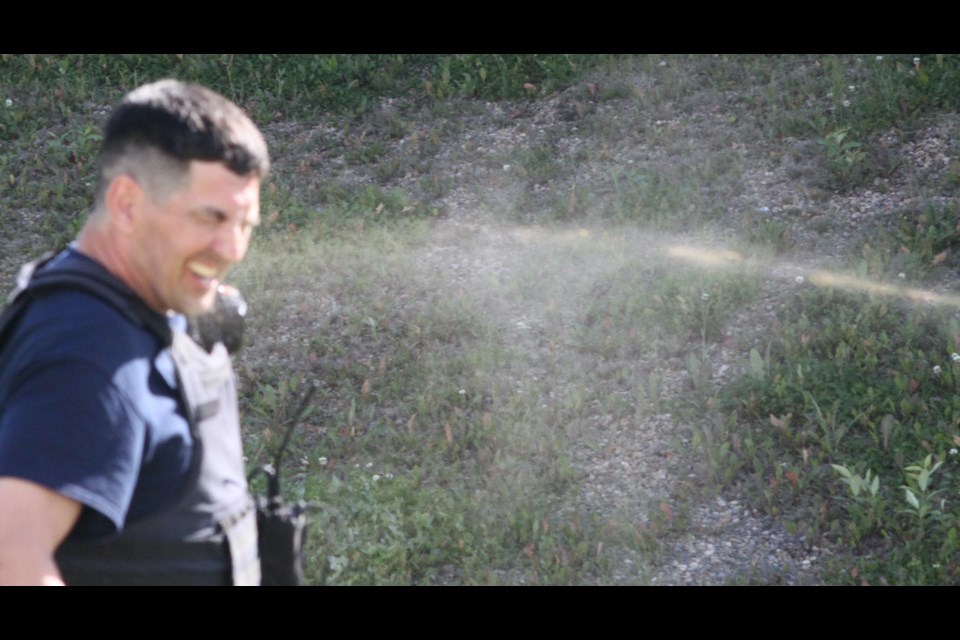 Joel Mosseau, a recruit in the Lac La Biche County Peace Officer Training program, reacts after being sprayed during an exercise which took place recently at the Law Enforcement Training Center.
