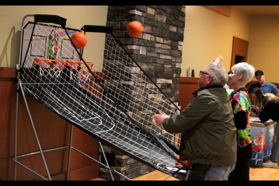 Bev Moghrabi and John Toutant try their hand at the basketball game on offer at the Lac La Biche Regional Health Foundation’s annual Games Night, which took place on April 11 at the Bold Centre. Chris McGarry photo. 