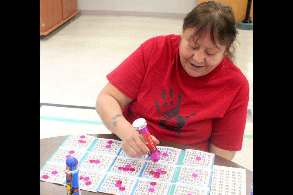 Joyce Allan looks over her cards as bingo numbers are called out. Chris McGarry photo. 