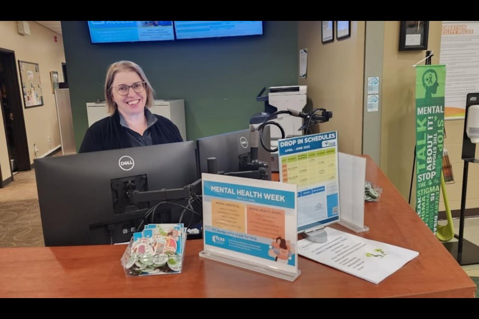Judy Lavigne of Lac La Biche County sits at the front desk of the Bold Centre, where free pins to promote mental health awareness were available during Mental Health Week, which ran from May 5-11. Photo supplied.  