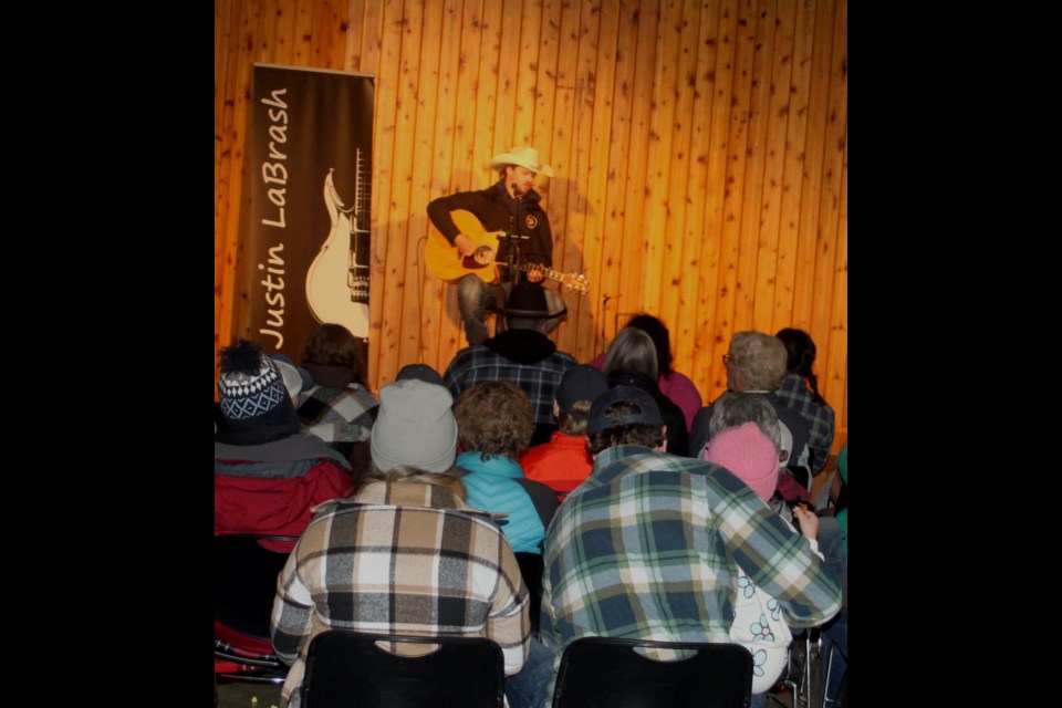   Yep, cowboy hats, toques and plaid coats - a staple of fashion for a chilly May long weekend concert in northern Alberta.     Chris McGarry photo. 