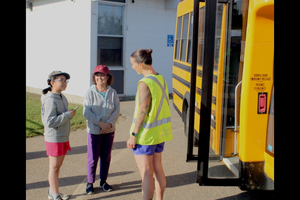Kissy Le and her grandmother, Nhi, speak with Marlee Hildebrandt, a bus driver with Northern Lights Public Schools (NLPS) during a session for the school division’s ‘Meet the Bus’ program, which took place at Vera. M. Welsh Elementary School in Lac La Biche on Aug. 28. Youngsters who participated in ‘Meet the Bus’ were introduced to a bus driver, learned basic safety rules, also took a short bus ride. Chris McGarry photo. 
