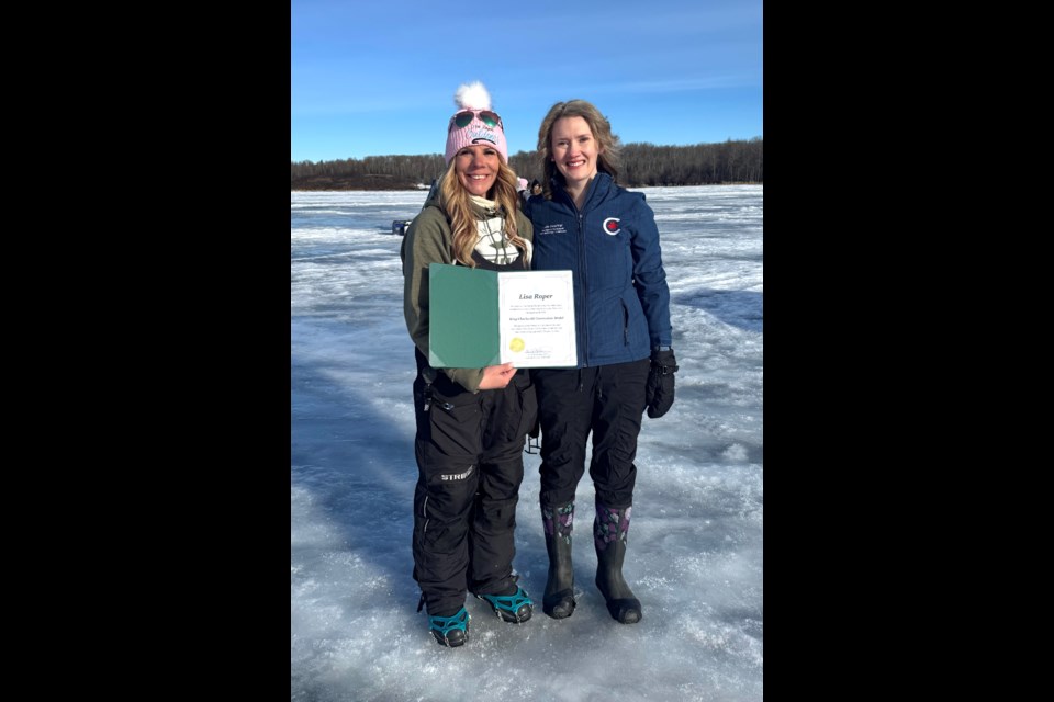 Lisa Roper, an outdoor enthusiast who hosts the TV program 'Lisa Roper Outdoors', received a King Charles III Coronation Medal from Laila Goodridge, Member of Parliament for Fort McMurray-Cold Lake on March 8 during Roper's fourth annual 'Ladies on Ice Fishing Adventure', which took place on Lac La Biche Lake adjacent to Sir Winston Churchill Provincial Park. Photo supplied. 