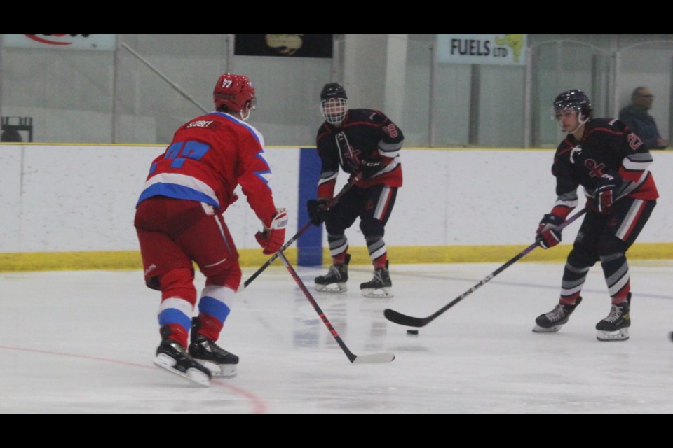 Parker Scobey of the Northern Alberta Lightning gets in the way of Lakers players Braden Swampy and Carl Horseman during the meeting between the two teams at the Bold Centre on Friday, Jan. 24. Lac La Biche won the game 8-2. Chris McGarry photo. 