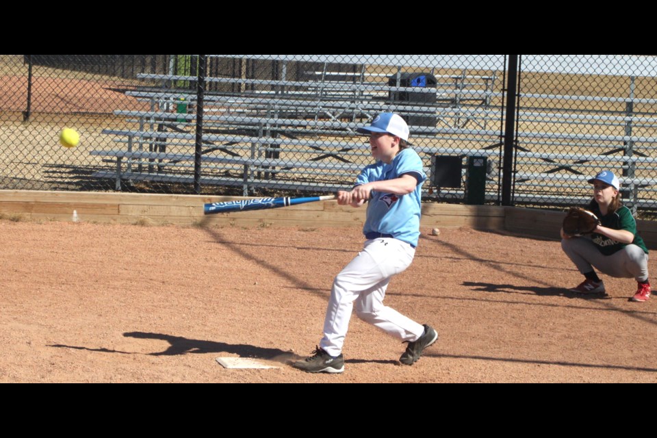 Leaf Flumian was busy hitting balls during practice while his sister, Asia, waited to catch those that flew her way. They were amongst a small group of local softball players who were getting in some practice ahead of the season. Practices for softball starts on April 22 at the Bold Center diamonds one and three. 
Chris McGarry photo.  