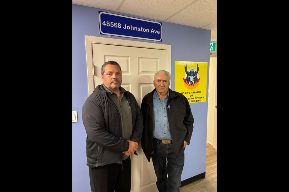 This year, March 3 marked the 20th anniversary of the Mayerthorpe shooting in which Constable Leo Johnston, who was originally from the Lac La Biche area, along with RCMP constables Brock Myrol, Peter Schiemann, and Anthony Gordon, were killed in the line of duty.  


Lee Johnston, Leo Johnston’s identical twin brother, and Ron Johnston, Leo’s father, stand underneath a sign to the scenario room at the Law Enforcement Training Centre in Lac La Biche which was recently named in honour of Leo. Photo supplied. 
