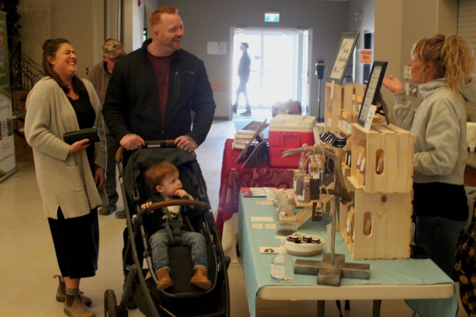 Marouelli shares a laugh with Patrick and Sarah Kerr, who were at the April 19 farmers market with their son, Gregor. Chris McGarry photo. 