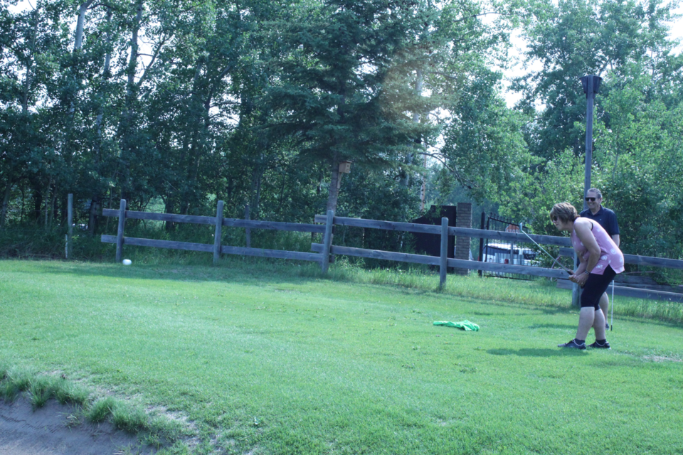 Lois Cusack chips her ball over a bunker in the hopes of finding the green ... or the hole. Chris McGarry photo.