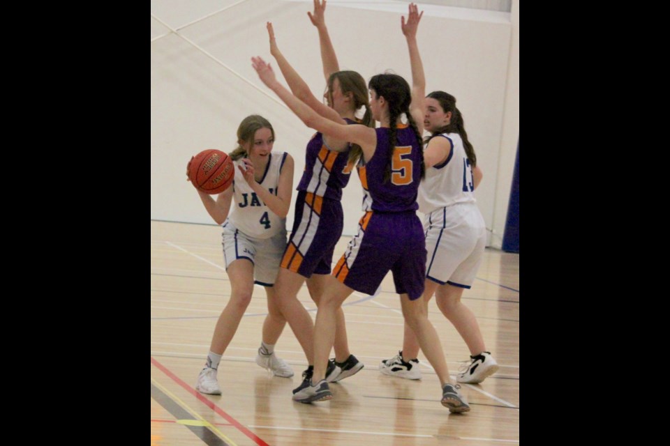 Hands Up: Madi Przybylski of the JAWS Sharks searches for an opening through Lloydminster Barons defenders during Friday’s match. The Barons won the game, the opening match of the weekend tournament hosted by JAWS at the Bold Center 46-28.     Photo: Chris McGarry photo.