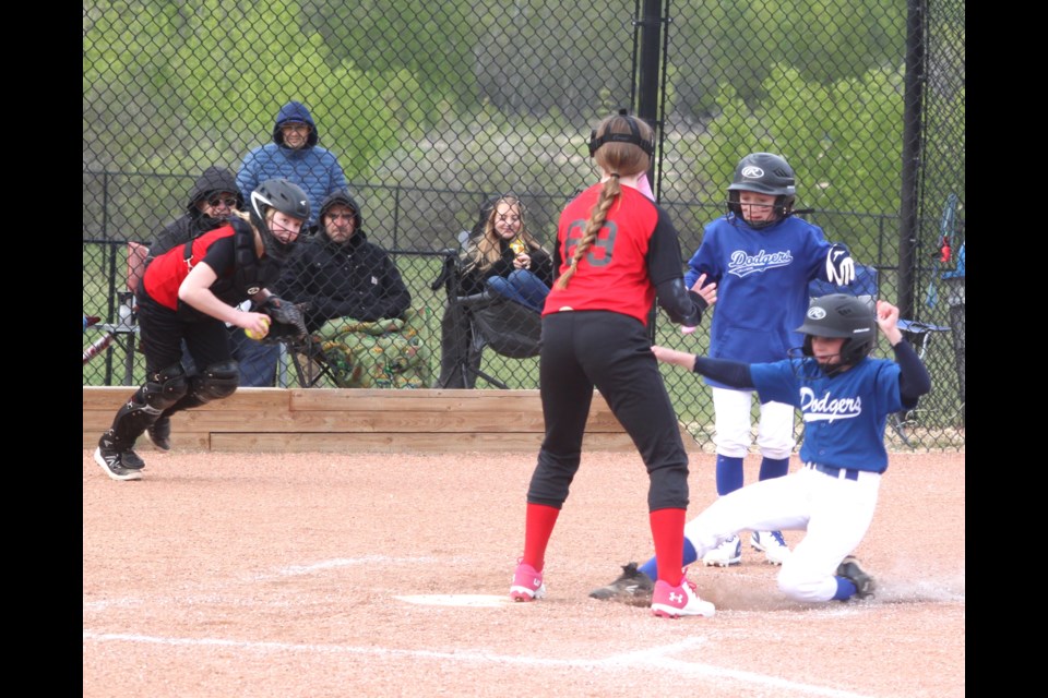 Lac La Biche Dodgers U13 player Makenna Colosimo slides into home plate during the second inning of the team’s May 21 home game against the Boyle Bandits. The contest concluded with a 20-20 tie. Chris McGarry photo. 