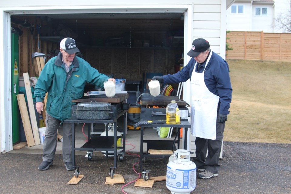 Volunteers cook and serve breakfast at the Community Volunteer Fair in Cold Lake on April 13. The day offered the chance for community members to learn more about the many volunteer opportunities available in the community. 