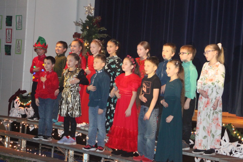 Grade 3 and 4 students at Ecole Plamondon School singing a traditional Russian Christmas carol known as a Malina. Chris McGarry photo.