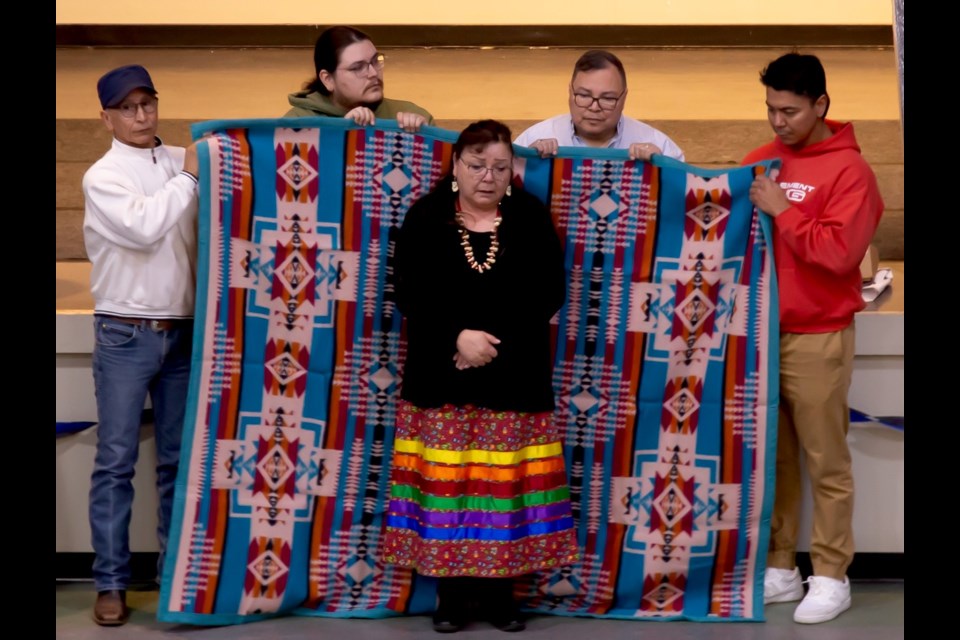 A traditional blanket ceremony was held for Marilyn Gladue  as a way for the community to show respect and gratitude for her achievements. Also in photo, from left-right: Leonard Jackson (councillor), Cole Gladue (Councillor), Gary Lameman (Chief, Beaver Lake Cree Nation), and Michael Lameman (Councillor). Submitted photo. 