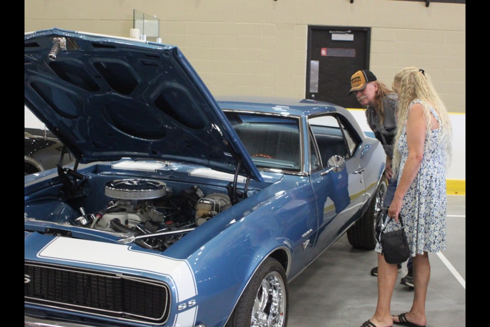 Mark Johnson and Angela Kjelland check out the 1967 Camaro that was on display inside of the Bold Centre Swamp Cats Arena during the Pow Wow Days Show and Shine event, which took place on Aug. 2. Chris McGarry photo.