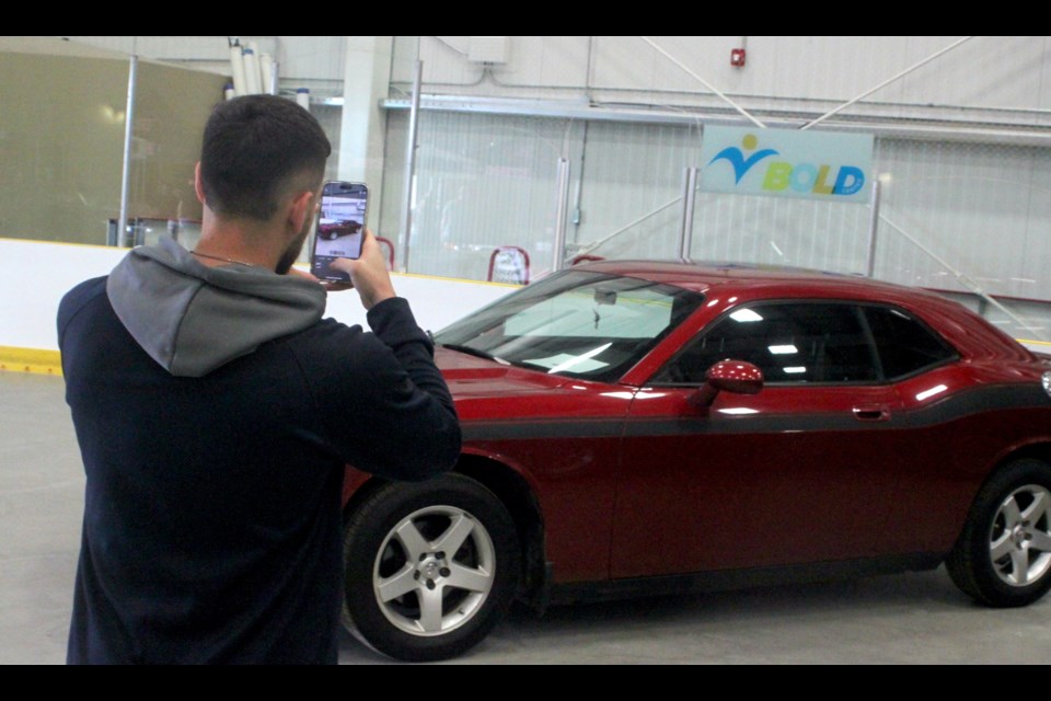 Metin Sefedini snaps a shot of a Dodge Challenger. Chris McGarry photo. 