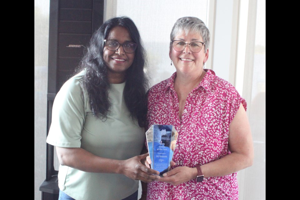 MJ Siebold, right, is the 2025 Citizen of the Year. Siebold, who has been involved with various initiatives in the Lac La Biche community, including founding the Lac La Biche Regional Humane Society, received the award from Hazel Costa, president of the Lac La Biche and District Chamber of Commerce during the Pow Wow Days and Fish Derby community fish fry, which was held at place on July 31 at McArthur Place. Chris McGarry photo. 
