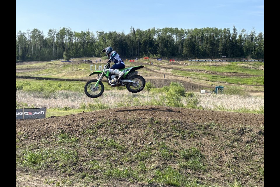 Riders in the Pre-Mix Moto 1 class tear down the track during a high-speed heat, kicking up dirt as they battle for the lead on their two-stroke machines.

Photo: Chantel Downes