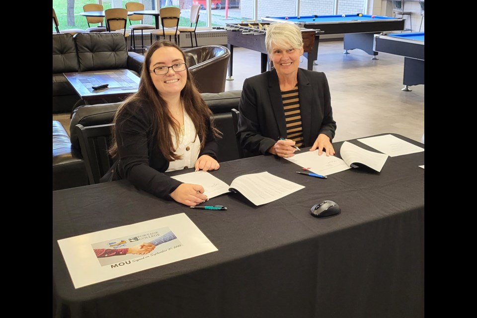 Kaylee Weigelt, chair of the Students’ Association of Portage College (SAPC) and Board of Governors Student Member, and Bev Moghrabi, Vice President, Student and College Services for Portage College, at the signing of the memorandum of understanding (MOU) between college administration and the SAPC, which took place recently. -- Submitted photo. 