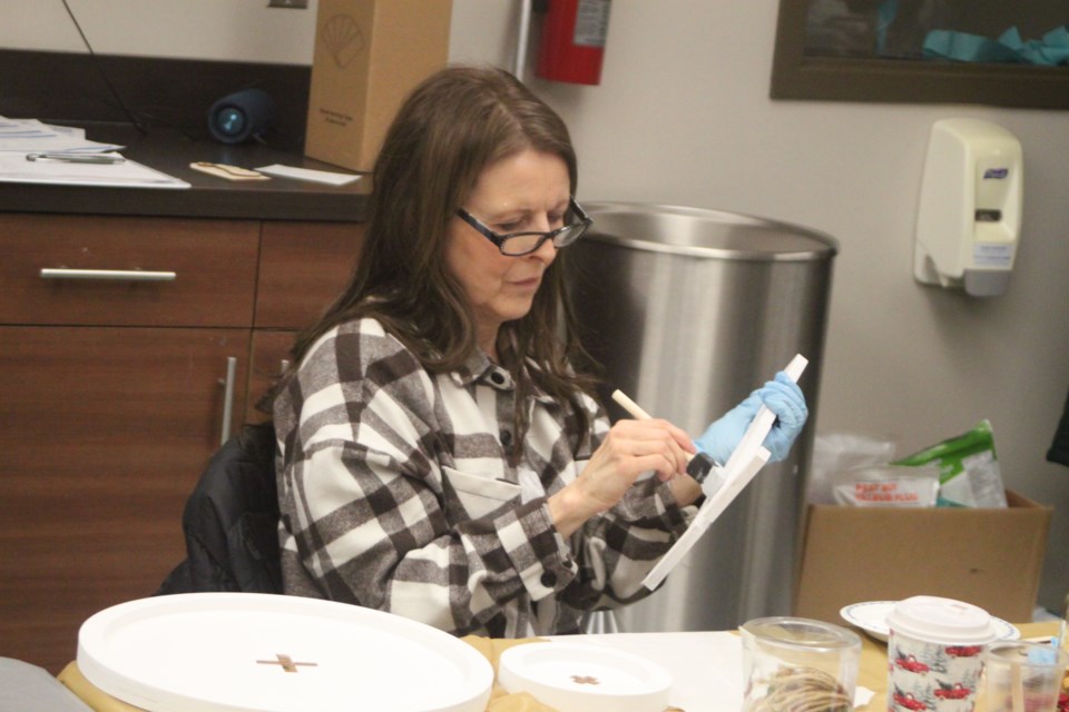 Vivian Moghrabi paints pieces of her tiered serving tray that was later assembled. Chris McGarry photo.