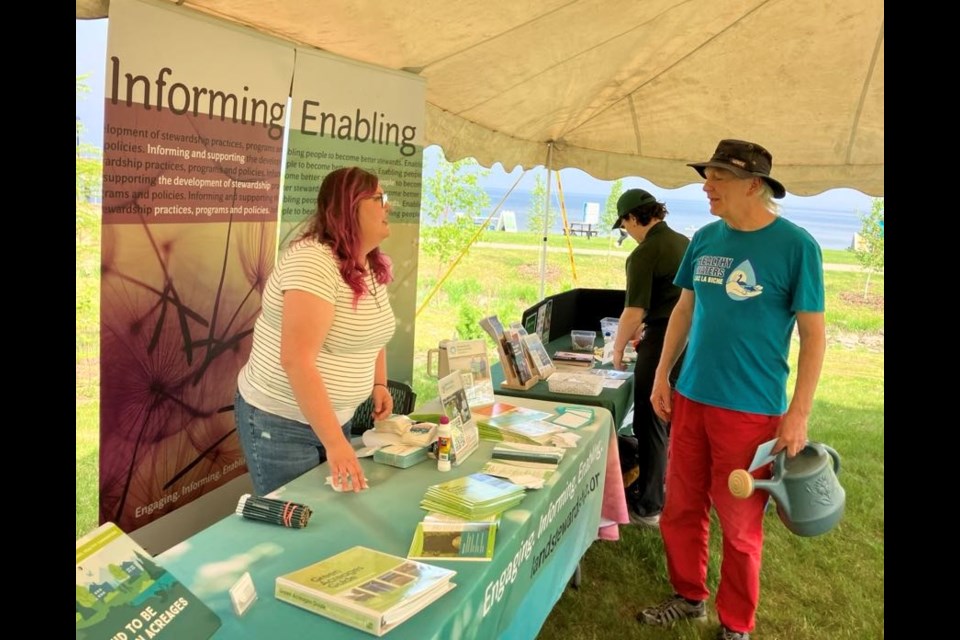 Pamela Billey, an outreach engagement coordinator with the Edmonton-based Land Stewardship Centre, chats with Brian Deheer at the launch party for Environment Week in Lac La Biche County, which took place on May 31 at McArthur Park. Chris McGarry photo.