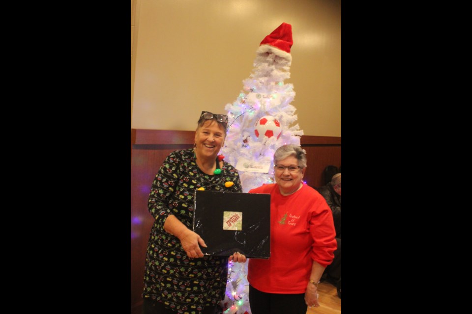 On Nov. 26, Pat Boon Anderson, right, chairperson of the Festival of Trees organizing committee and cofounder of the event, which started in 2010, was recognized for her hard work and dedication. She was given a scrapbook with highlights of each year of the festival dating back to the beginning. With her is Alice Thompson, ticket director for the Festival of Trees. / Chris McGarry photo. 