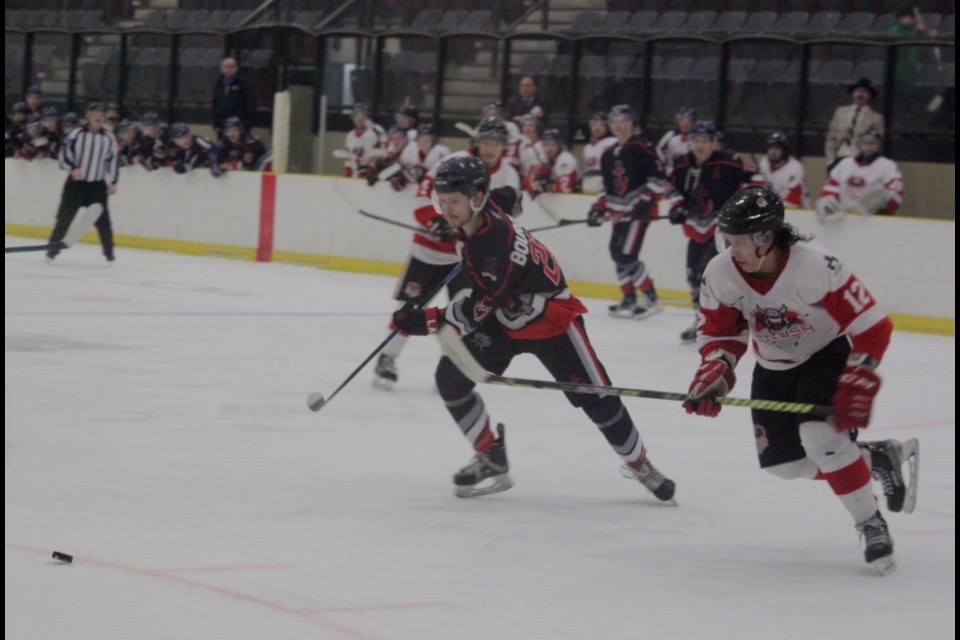 Lac La Biche Lakers forward Patrick Bourque and Crowsnest Crush forward Nathaniel Heese make a run for the puck at the same time during the first game of the National Junior Hockey League (NJHL) finals, which took place on March 21 at Lac La Biche’s Bold Centre. The Lakers won the contest 7-0. Chris McGarry photo.