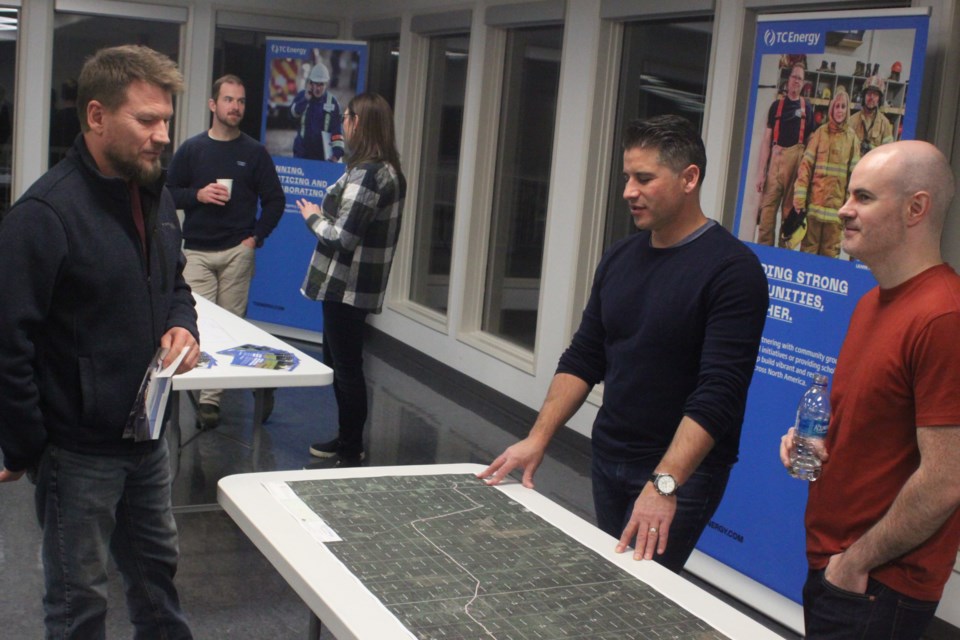 Lac La Biche County mayor Paul Reutov goes over a map of the proposed Blackrod Connection Project with TC Energy representatives Matt Quinlan and Cody Knorr, members of the project development and execution team. The open house was held at McArthur Place on Tuesday, Nov. 16. The Blackrod Connection Project, if approved, will start in 2024 and is expected to up and running the following year. It proposes the construction of two 25-km pipelines as well as associated facilities in Lac La Biche County. Chris McGarry photo. 