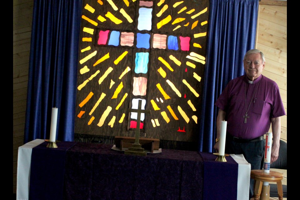 Phil Hink, pastor of Lord of Glory Lutheran Church in Lac La Biche, stands next to the altar inside the church. Lord of Glory, in addition to holding customary Easter services, is also part of a local four-group that gathers on Good Friday for an ecumenical service at the Bold Centre. Chris McGarry photo. 