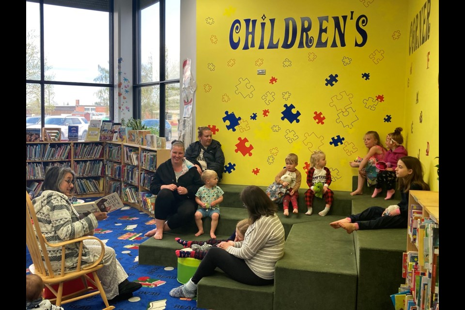 Library programmer Monique Poulin reads The Very Sleep Bear at a pyjama story time.