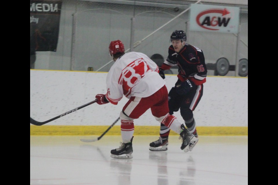 Quinten Quinney of the Lac La Biche Lakers is confronted by High Prairie Red Wings player Cameron Vaughn. Chris McGarry photo. 