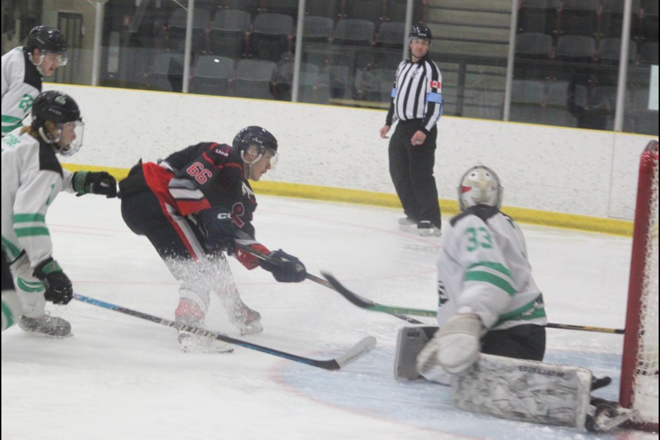 Lac La Biche Lakers player Quinten Quinney launches an attack on the net of Gibbons Pioneers goaltender Michael Friesz during the first period of the Lakers’ final game of the season, which took place on March 1 at the Bold Centre. Lac La Biche won the game 11-4. Chris McGarry photo. 