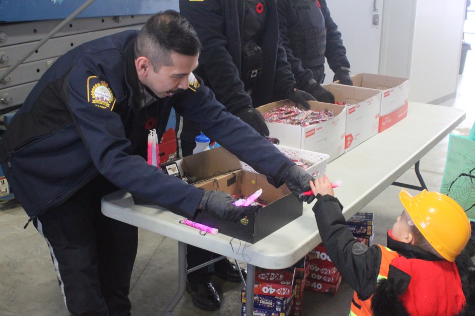 Firefighters and peace officers were dishing up the treats to youngsters and families at Tuesday night's Halloween event at the Protective Services building.