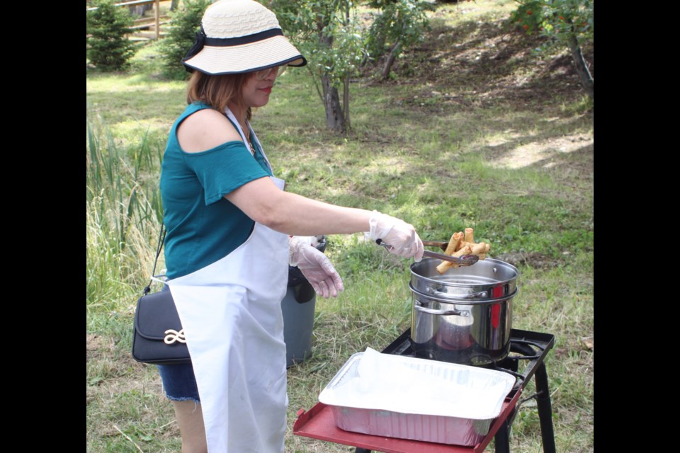 Raquel Masuba was busy cooking Filipino spring rolls during day two of the cultural event. Chris McGarry photo.