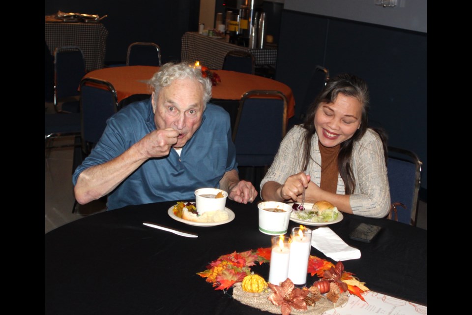 Reed Gauthier and Ludi Coyoca eat some of the homemade stew and rolls that were served at this year’s Plamondon Harvest festival. Chris McGarry photo. 