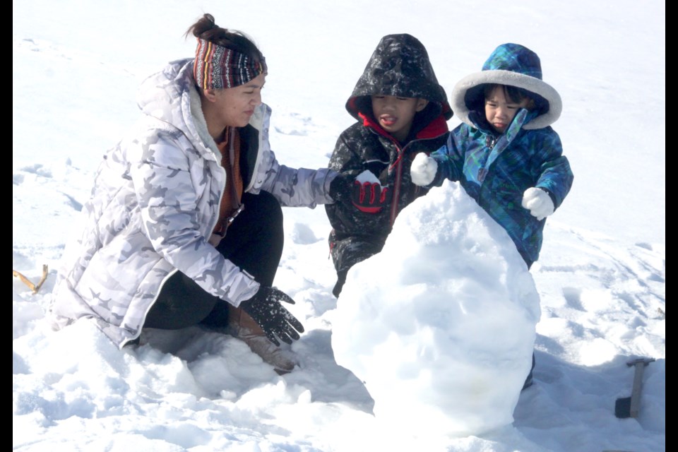 Karen Langato and her children, Keandra and Kenzo were using the above average temperatures across the region  to enjoy a snowman-making afternoon on Lac La Biche lake Saturday. For this week's continuing warming trend, see the long range forecast, click the WEATHER icon at the top of our www.lakelandtoday.ca webpage. Chris McGarry photo. 