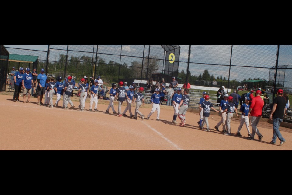Members of the 11U Lac La Biche Dodgers and 11U St. Paul Storm shake hands after the final game of the tournament in which the Dodgers won 20-9 to bring home the gold. Chris McGarry photo. 