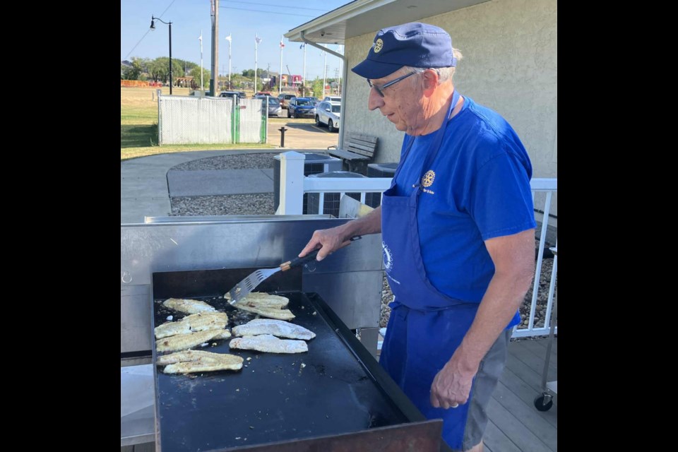 Tim Polzin, president of the Rotary Club of Lac La Biche, fries some walleye that was served to the large group of people who were in attendance for the Pow Wow Days community fish fry at McArthur Place on July 31. Chris McGarry photo. 