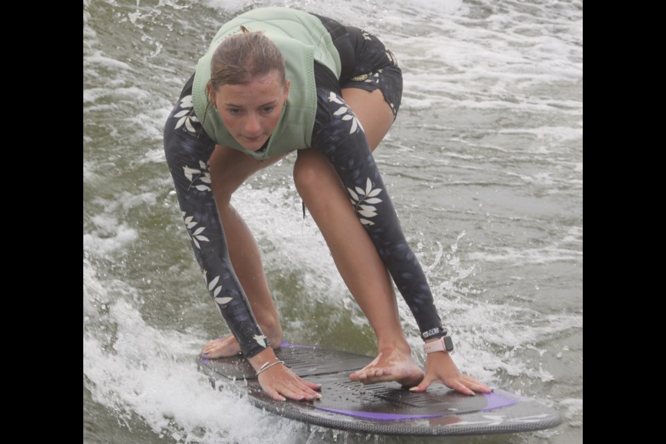 Tori Tost of Calgary holds on as she rides the waves of Beaver Lake during the Alberta Wake Tour event that took place in Lac La Biche on July 19. Tost of amongst a ground of around 25 wake surf enthusiasts who took part in the competition. Chris McGarry photo. 