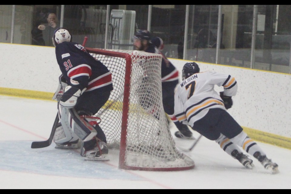 Voyageurs goaltender Tresor Wotton remains as guard as Thunder forward skates around his net. Chris McGarry photo. 