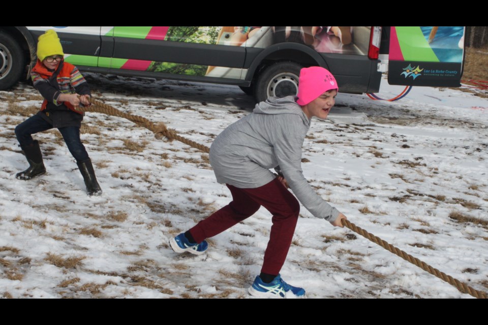 What would a fun family day event be without a good old-fashioned tug of war? Joshua Gauthier and Landen Lameman enjoy themselves as they struggle to keep from being forced to the ground during a bout. Chris McGarry photo.