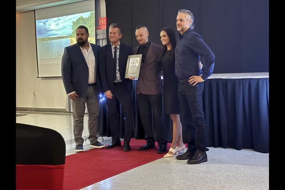 Varughese family accepts the Hall of Fame award on behalf of their father.