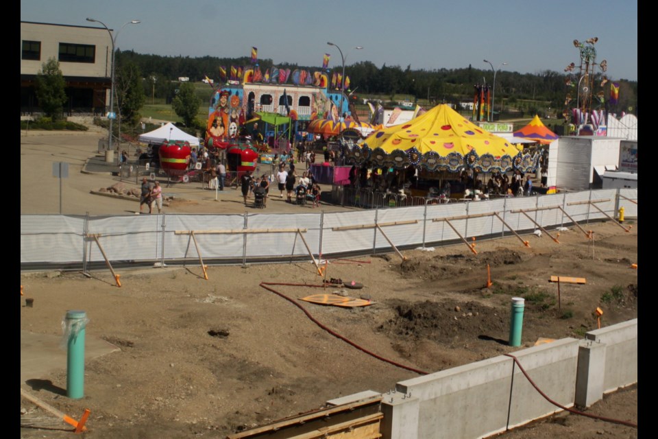This year, the Lac La Biche Summer Days midway was held next to the site of ongoing construction to build the community's new $44.9 million aquatic centre, which is slated to be open by mid-2026. Chris McGarry photo. 
