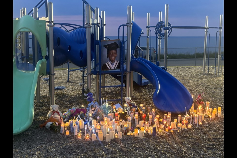 A photo of Ibukun was placed on the playground at St. Dominic Elementary School after the candlelight vigil.

Photo/Chantel Downes